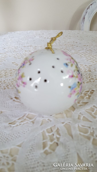 A beautiful porcelain ball holding a potpourri with a bouquet of flowers