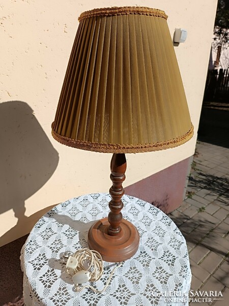 Floor lamp on a wooden base with a textile shade