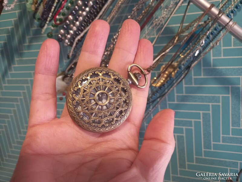 Beautiful antique bronze pocket watch with an ornamental pattern.