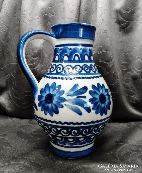 Glazed blue ceramic jug with flowers