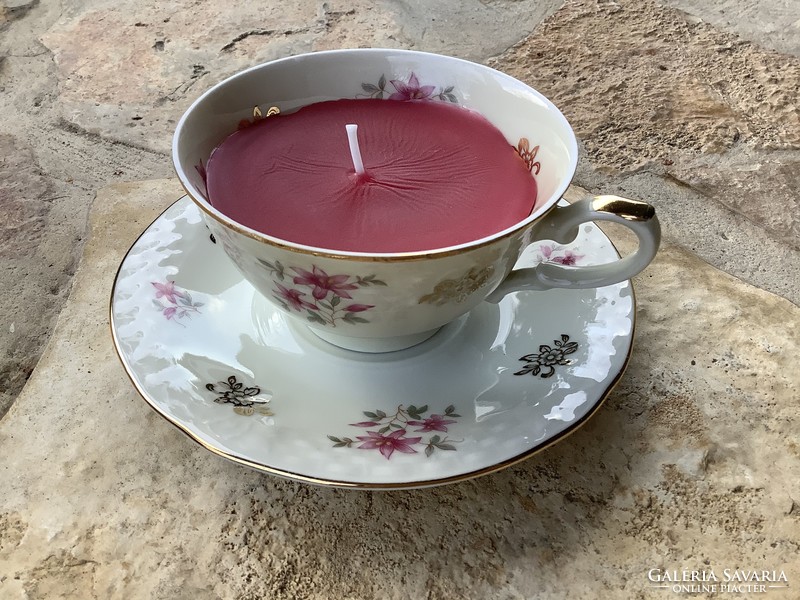 Tea or cappuccino porcelain cup with a bottom and a pair of scented candles