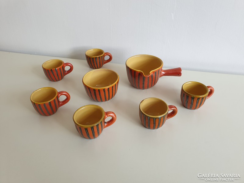 Old retro glazed ceramic coffee set with coffee pourer and coffee cups