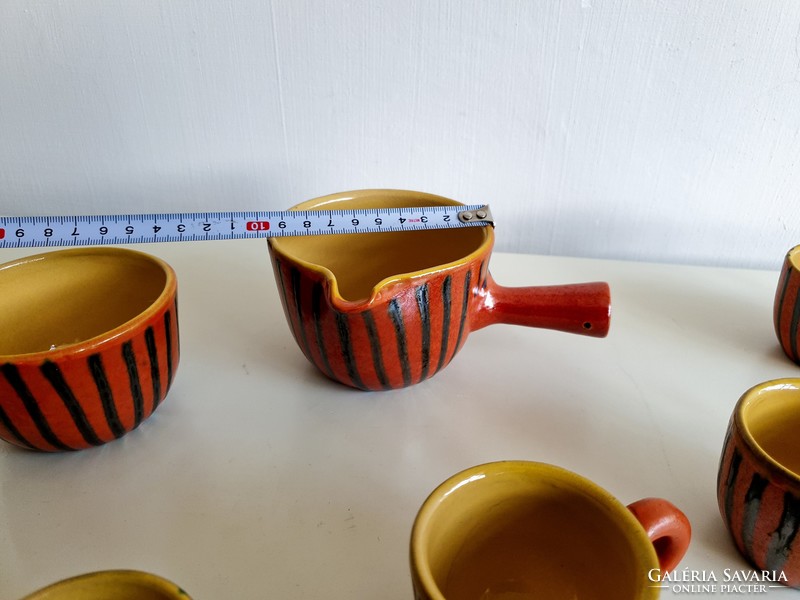 Old retro glazed ceramic coffee set with coffee pourer and coffee cups