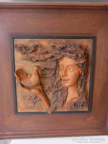 Girl with a dove - terracotta relief