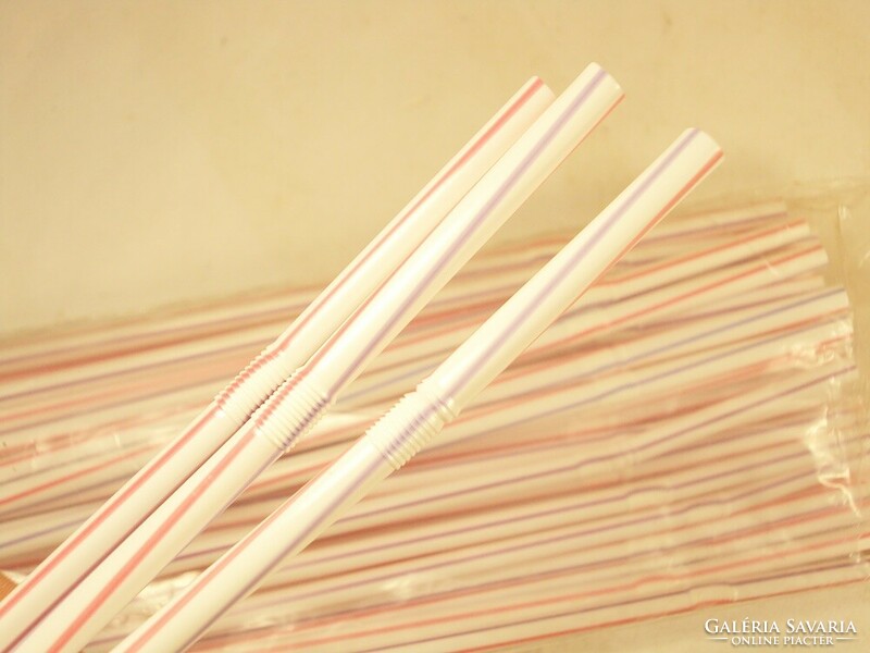 Old retro plastic straw with red purple white stripes from the 1980s