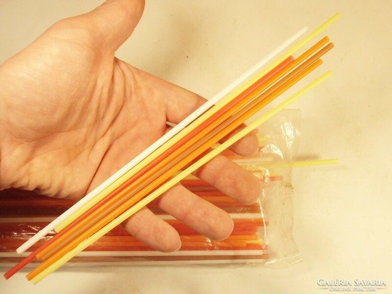 Old retro plastic straw white lemon yellow orange red brown from the 1980s