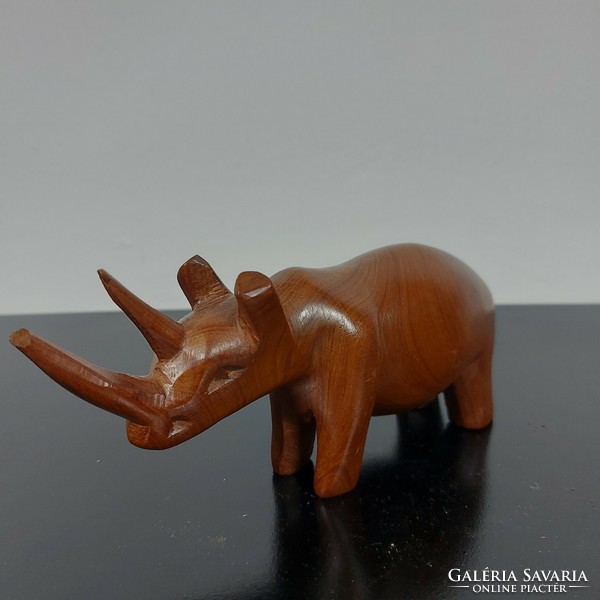 A sculpture of a rhinoceros carved from wood