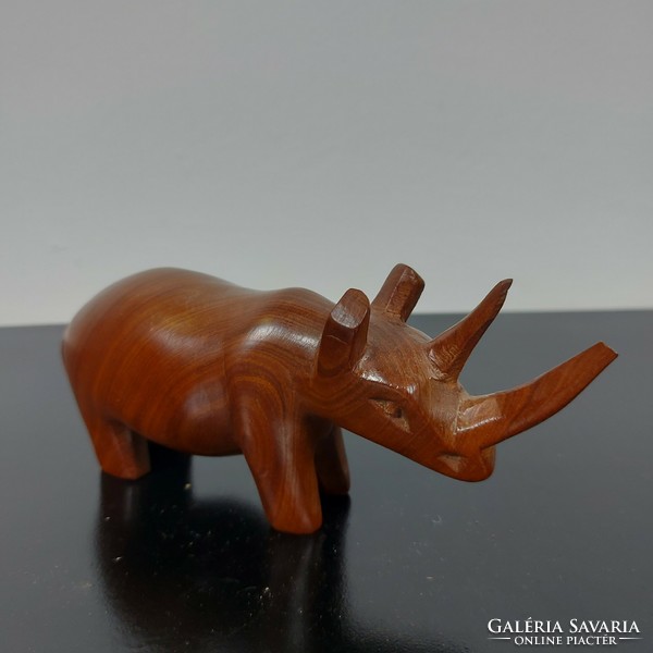 A sculpture of a rhinoceros carved from wood