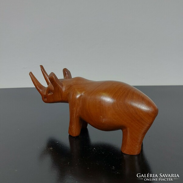 A sculpture of a rhinoceros carved from wood