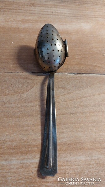 Old tea egg and tea herb spoon with patina