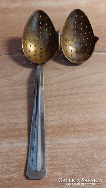 Old tea egg and tea herb spoon with patina