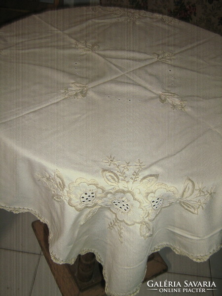 Beautiful crocheted tablecloth with beige flowers on a beige background