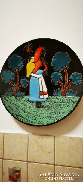 A pair of African glazed ceramic wall plates.
