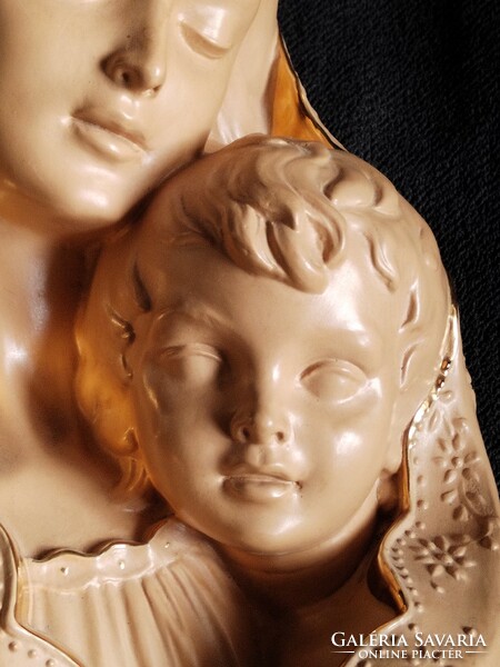 Mary with baby Jesus is a large, gilded, Italian terracotta relief