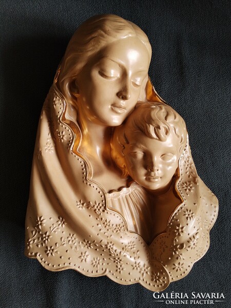 Mary with baby Jesus is a large, gilded, Italian terracotta relief