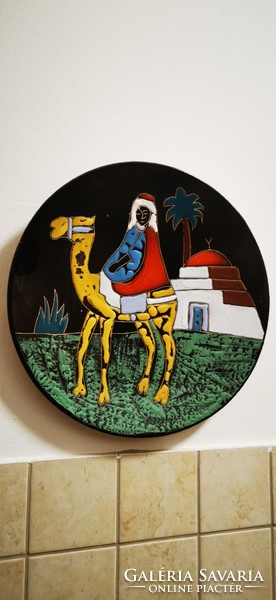 A pair of African glazed ceramic wall plates.