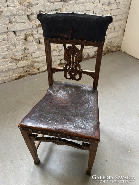 Carved chair with patterned leather seat