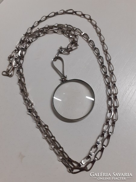 Old neck magnifying pendant on a long necklace in good condition