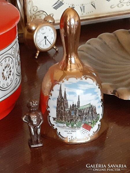 Beautiful porcelain richly decorated with gold bells with a picture of a castle