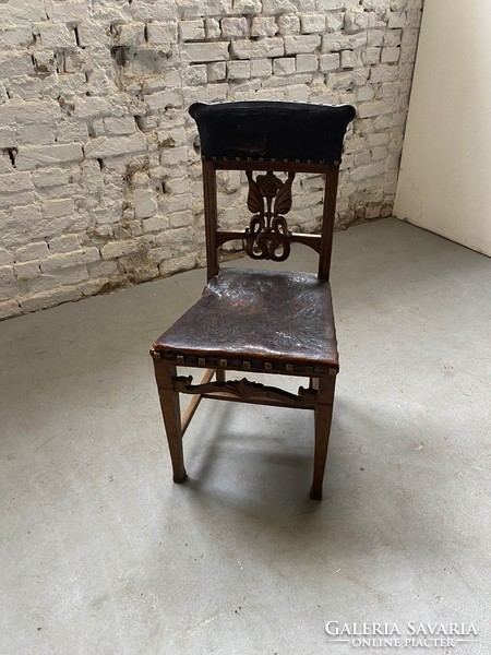 Carved chair with patterned leather seat