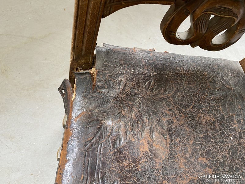 Carved chair with patterned leather seat