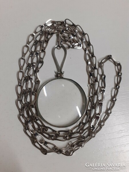 Old neck magnifying pendant on a long necklace in good condition