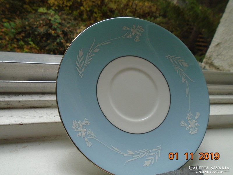 Minton plate with white enamel cameo pattern on a turquoise background