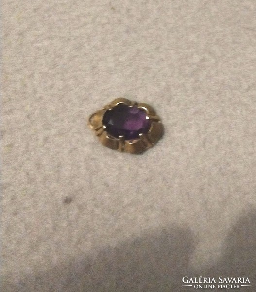Gold colored pendant with artificial amethyst stone is good