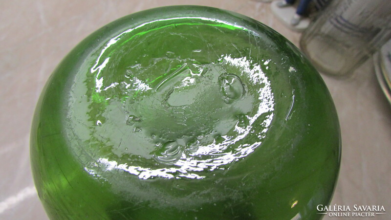Broken green glass jug