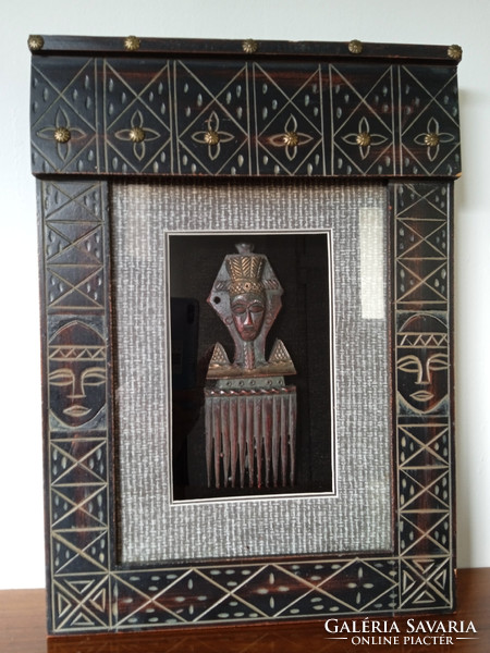 A special African showcase picture with an inlaid metal replica of a tribal comb