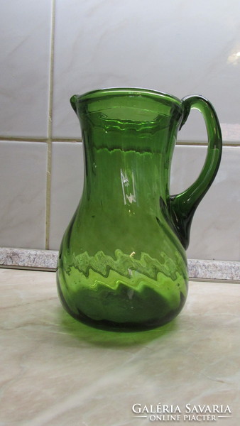 Broken green glass jug