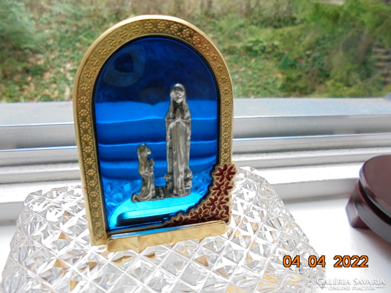 The Virgin of Lourdes embossed metal image on cobalt glass, in a gilded enamel floral frame