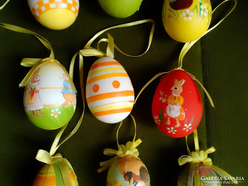 Nine male Easter eggs hand-painted with a colorful pattern on a plastic base are spring decorations for sprinklers