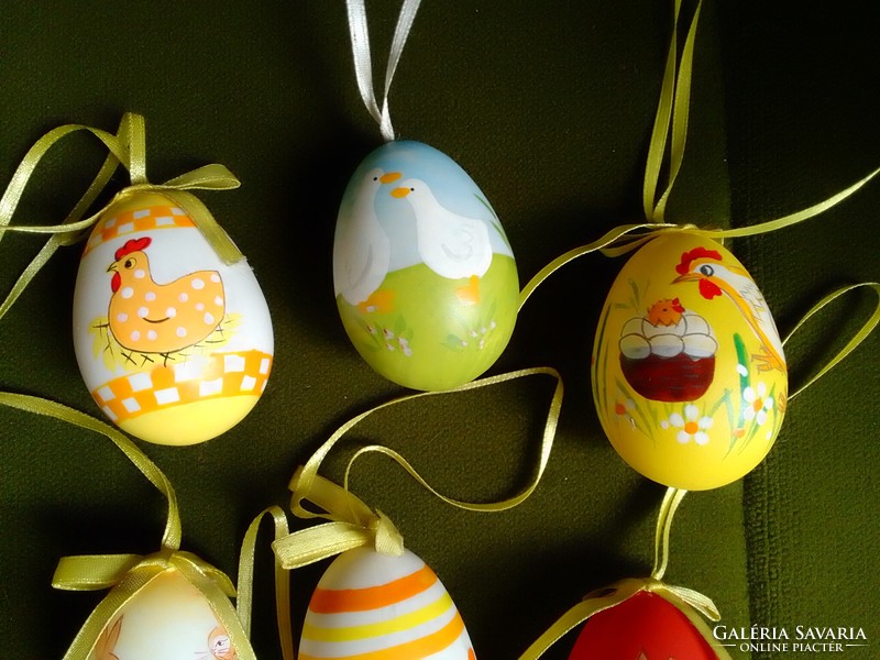 Nine male Easter eggs hand-painted with a colorful pattern on a plastic base are spring decorations for sprinklers