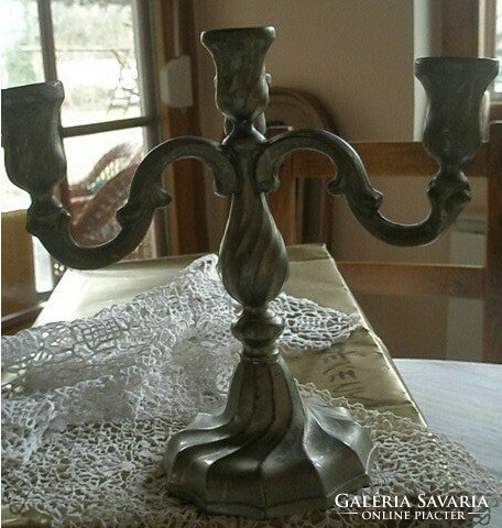 Old heavy metal four-arm candle holder - art&decoration