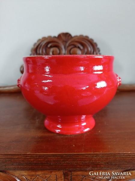 Red ceramic bowl with a lion's head
