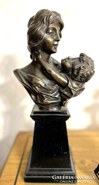 Bust of a mother with her child - bronze statue on a marble plinth