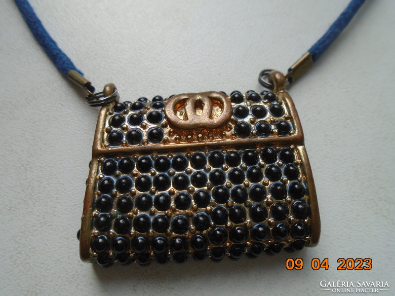 Fire-gilded bronze miniature double-walled Gucci bag pendant, on a string.