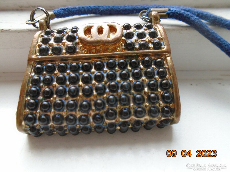 Fire-gilded bronze miniature double-walled Gucci bag pendant, on a string.