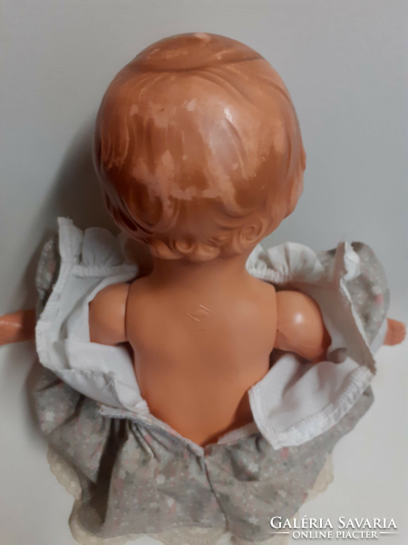 Old rubber doll with a nice face, in a good condition, in a nice dress with a turtle mark on the back