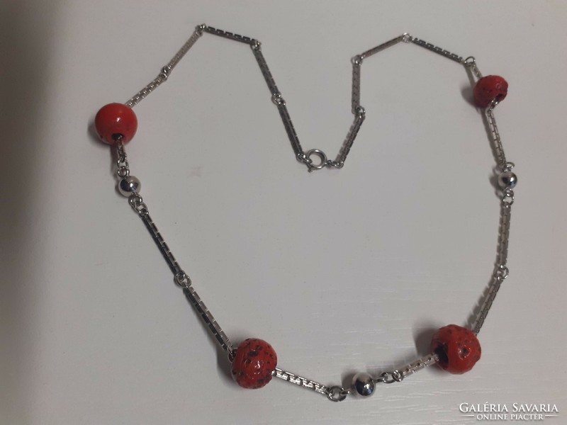 Thick stainless steel square necklace with red coral colored stones on it