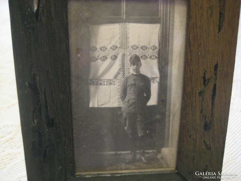 The photo of the little soldier from the 1910s, in a nice wooden frame, covered with leather on the back