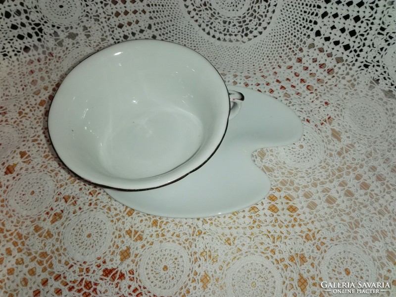 Porcelain tea cup with saucer.