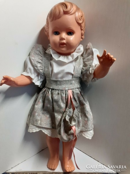 Old rubber doll with a nice face, in a good condition, in a nice dress with a turtle mark on the back