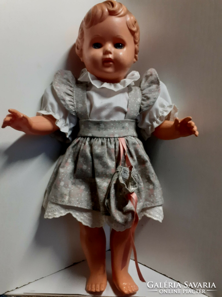 Old rubber doll with a nice face, in a good condition, in a nice dress with a turtle mark on the back