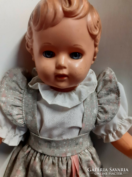 Old rubber doll with a nice face, in a good condition, in a nice dress with a turtle mark on the back