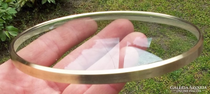 Convex watch glass with a copper rim