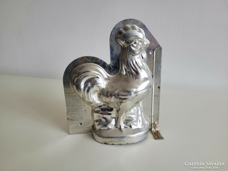 Old metal baking mold in the shape of a rooster, chocolate pouring mold, chicken poultry, Easter confectionery