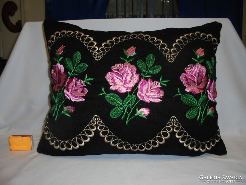 Old, hand-embroidered decorative pillow - pink on a black background