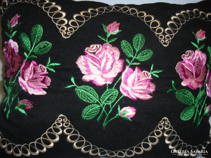 Old, hand-embroidered decorative pillow - pink on a black background